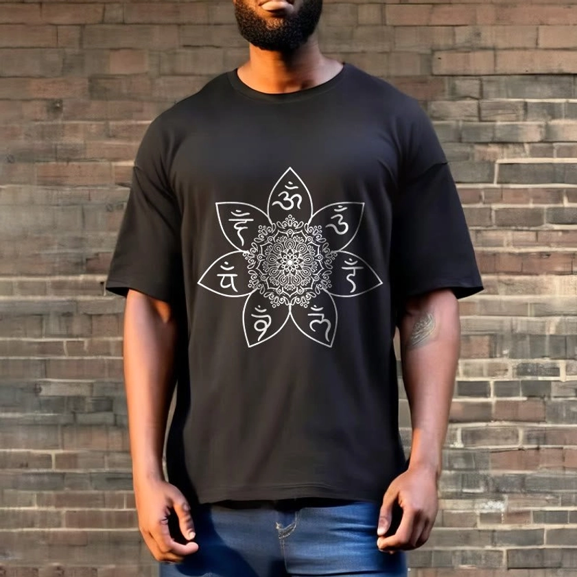 Om mani padme hum mandala t-shirt worn by male model outdoor street style black tee with blue jeans brick wall background