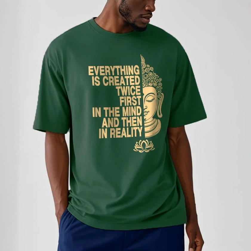 Close-up detail of Buddhist t-shirt gold print showing Buddha head lotus flowers and created twice slogan