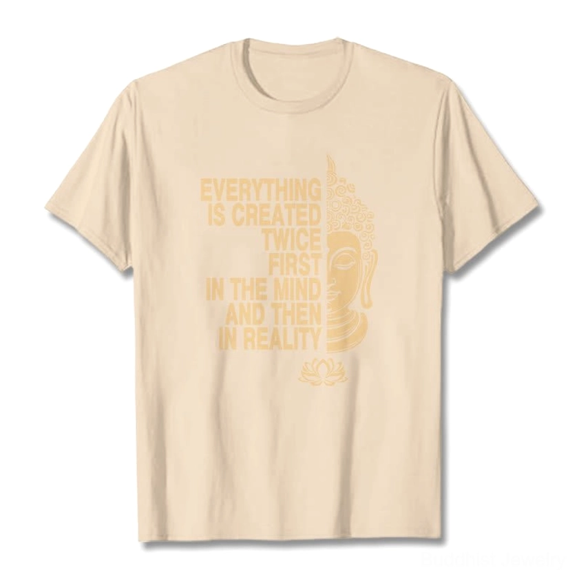 Light tan Buddhist t-shirt flat lay with gold print Buddha lotus and manifestation slogan