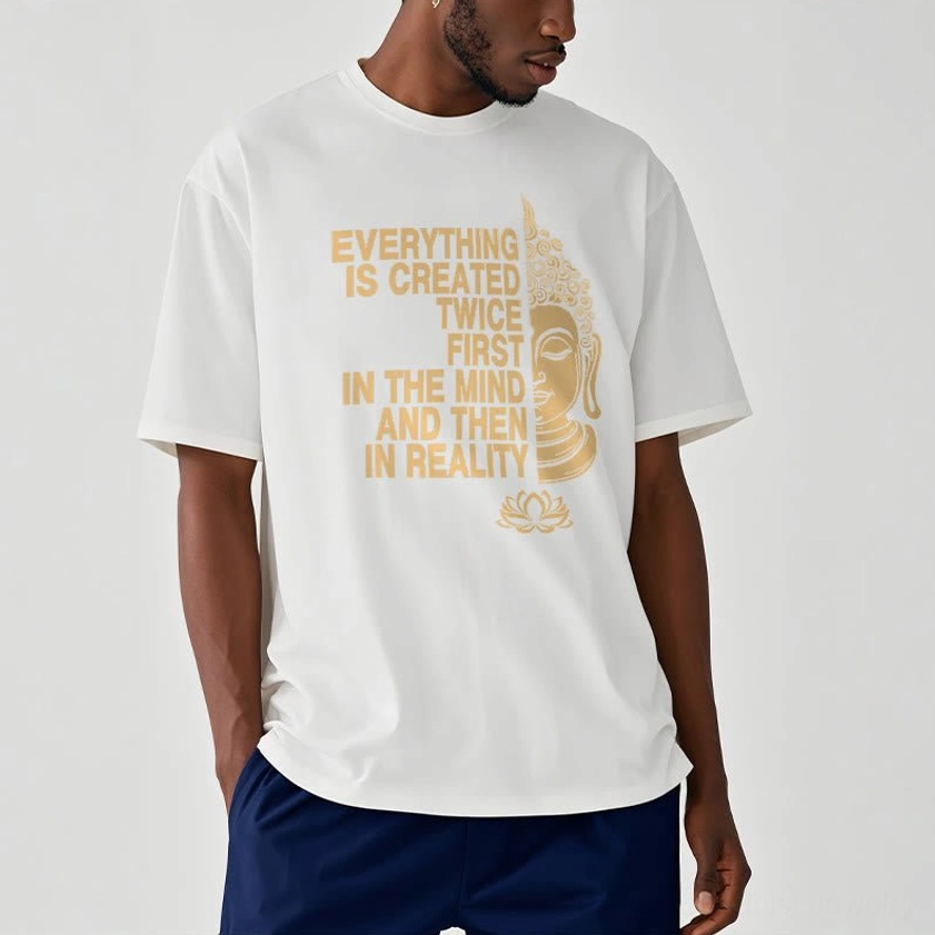 Person wearing white Buddhist graphic tee with navy pants and gold printed spiritual design