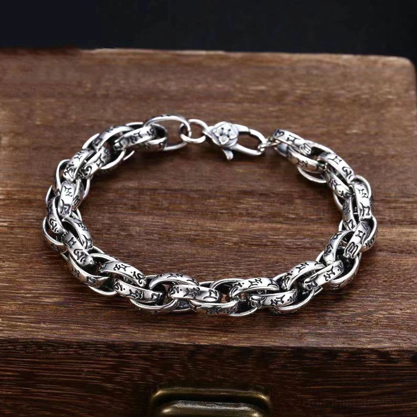Vintage style Buddhist mantra bracelet with lobster claw clasp on wooden jewelry box display