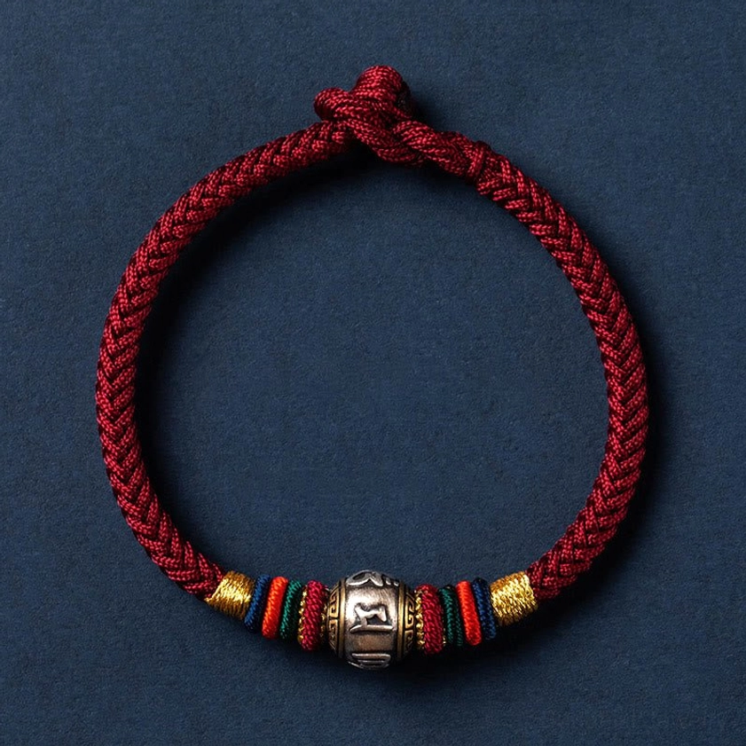 Single Om Mani Padme Hum Buddhist bracelet with deep red braided cord, colorful woven segments, and adjustable slip-knot closure