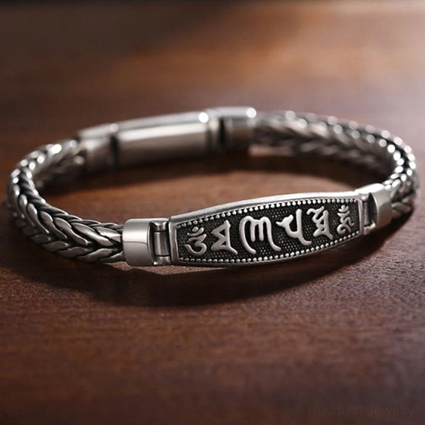 Side view of handcrafted Buddhist copper bracelet showing three-quarter perspective with raised embossed mantra plaque and magnetic clasp