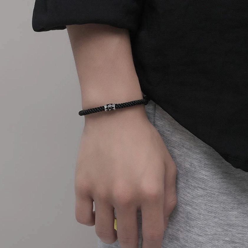 Worn sterling silver Buddhist string bracelet on wrist showing daily wear comfort and fit for meditation practice