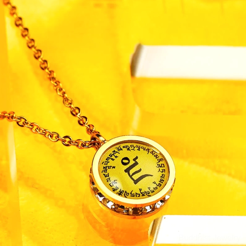 Close-up of Buddhist mantra pendant - sacred Om Mani Padme Hum text with gemstone-studded edge