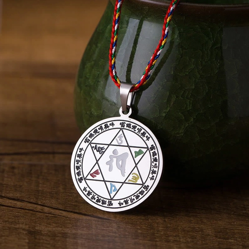 Buddhist mantra necklace pendant hexagram design with colorful woven rope titanium steel flat lay