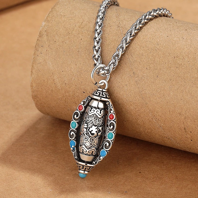 Buddhist Om Mani Padme Hum mantra necklace oblique side angle showing vintage silver finish and intricate carved patterns with gemstone accents