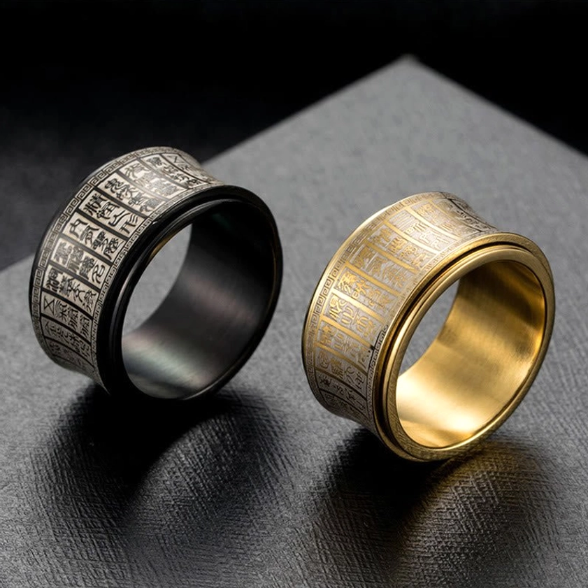 Top-down view of sacred Buddhist mantra engraved on titanium steel spinner ring