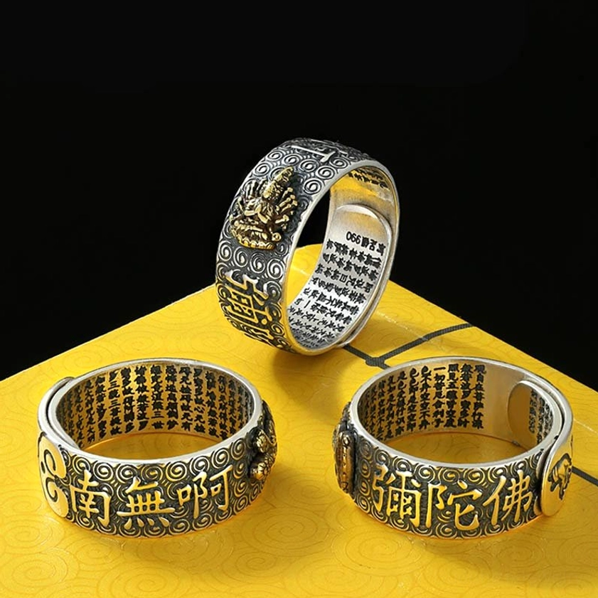 Adjustable Buddhist mantra rings collection displaying three styles with Namo Amitabha text and Buddha engraving, mixed silver and gold finish on yellow paper
