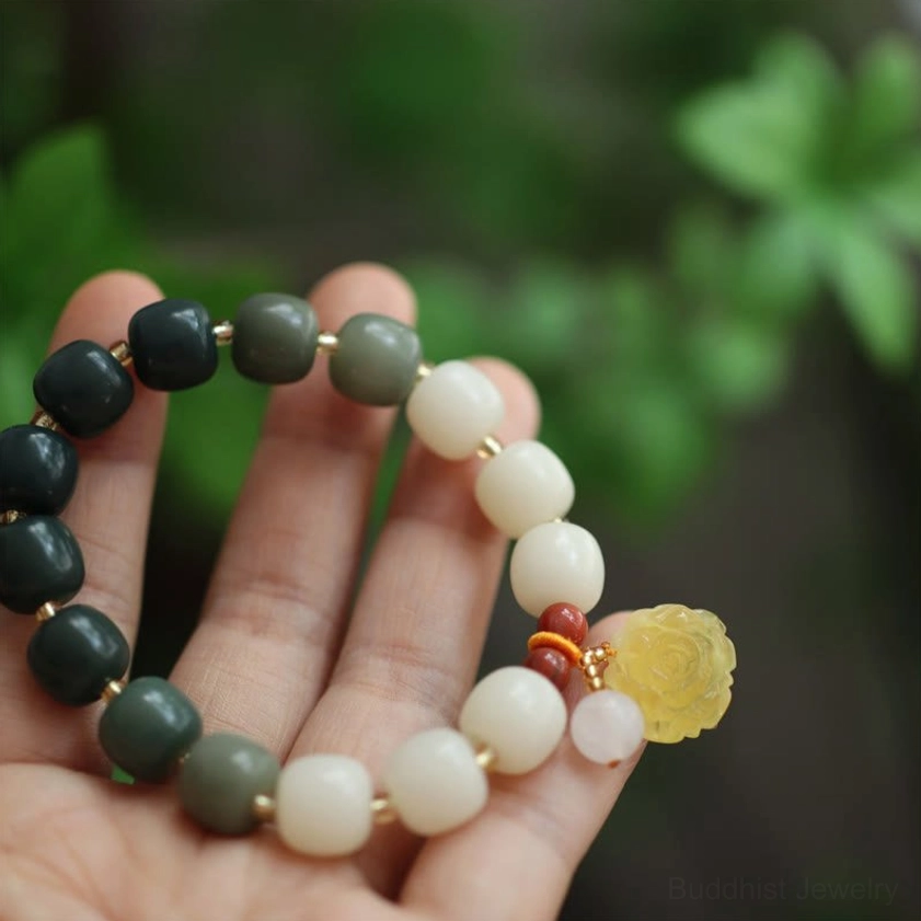 Clear overhead palm view of complete bodhi seed lotus peace bracelet with all gradient beads and spiritual charm decorations