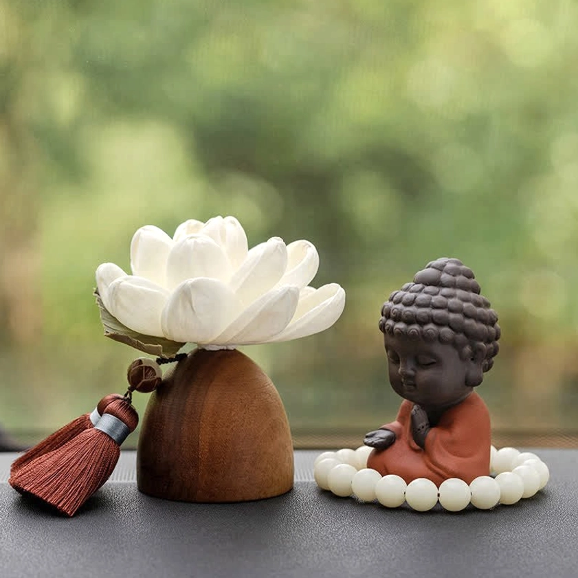 Meditation Buddha figurine with prayer beads beside on wooden surface, tabletop meditation setup