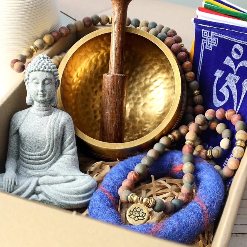 Complete Buddhist meditation healing gift bundle with singing bowl, mala beads, Buddha statue, prayer flags and felt cushion displayed in open gift box
