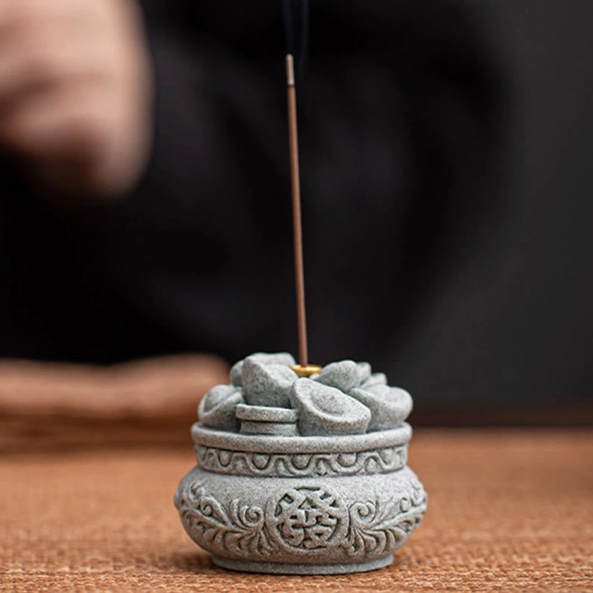 Buddhist incense burner three-quarter view showcasing matte gray texture and floral carved motifs