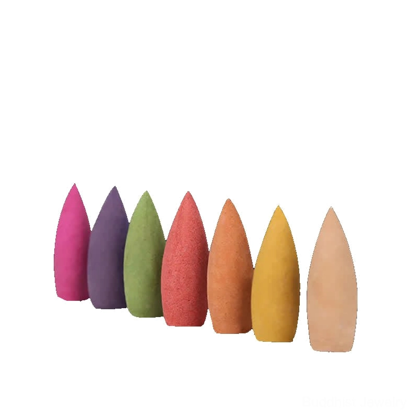 Solid color backflow incense cones in neat linear display showing seven-color Buddhist meditation collection against black background