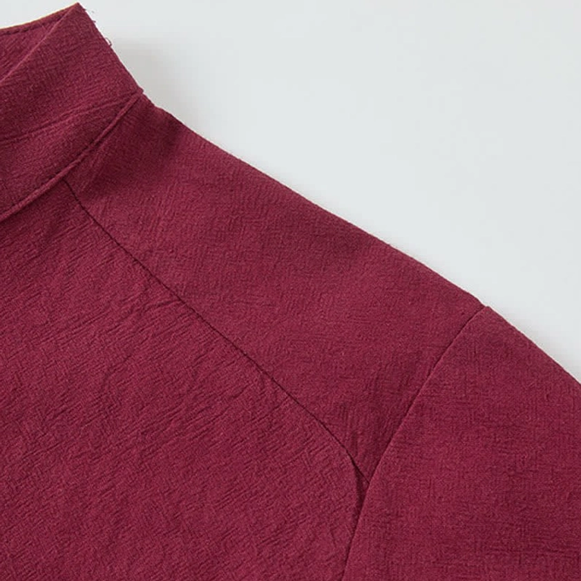 Shoulder seam and mandarin collar detail on burgundy Buddhist meditation shirt, tailored craftsmanship