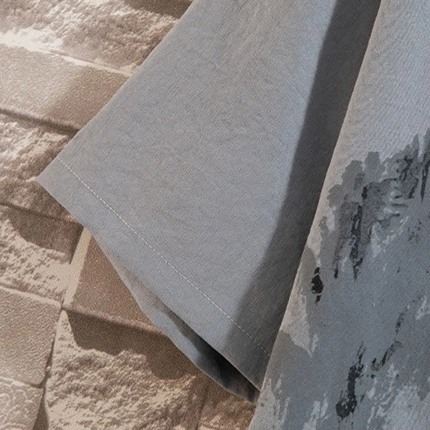 Short sleeve detail of Buddhist meditation linen shirt with ink-wash landscape print and natural fabric texture, showing craftsmanship