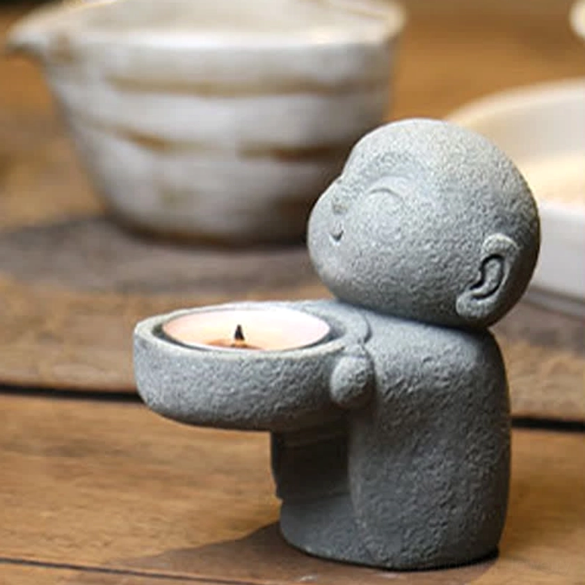 Buddhist resin candle holder monk figure detail - grey stone finish with contemplative peaceful pose