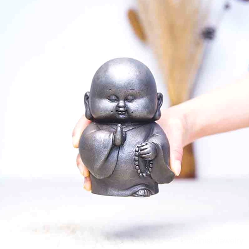 Handcrafted Buddhist monk iron resin statue featuring authentic aged patina and spiritual symbolism