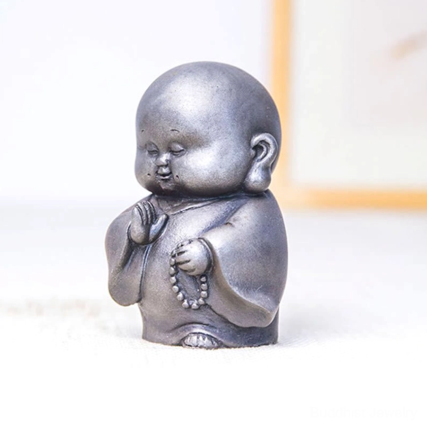 Cute Buddhist monk statue showing chubby friendly design with prayer beads and peaceful demeanor