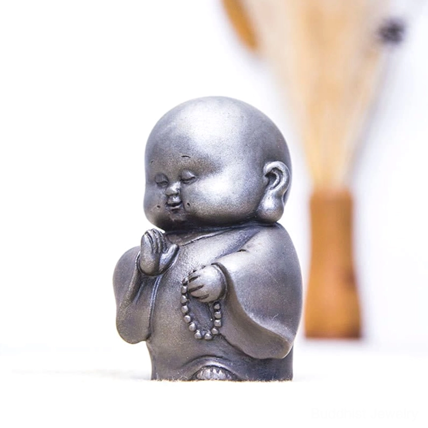 Handmade Buddhist monk statue showing detailed hand-sculpted features and authentic iron powder texture