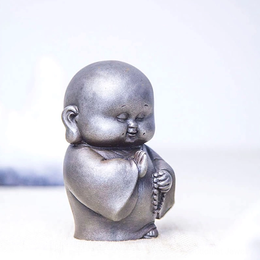 Iron powder Buddhist statue handmade monk figure with intricate craftsmanship and serene spiritual energy