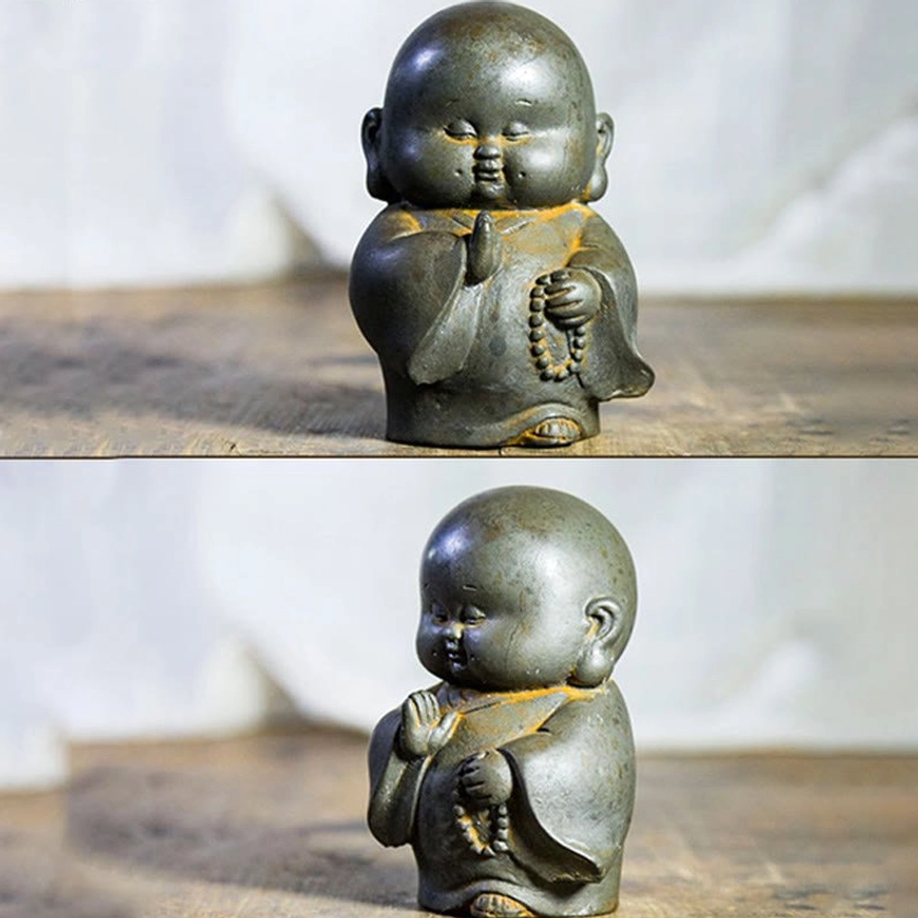 Handcrafted Buddhist monk statue front view with unique prayer hand gesture and dark rusty finish texture