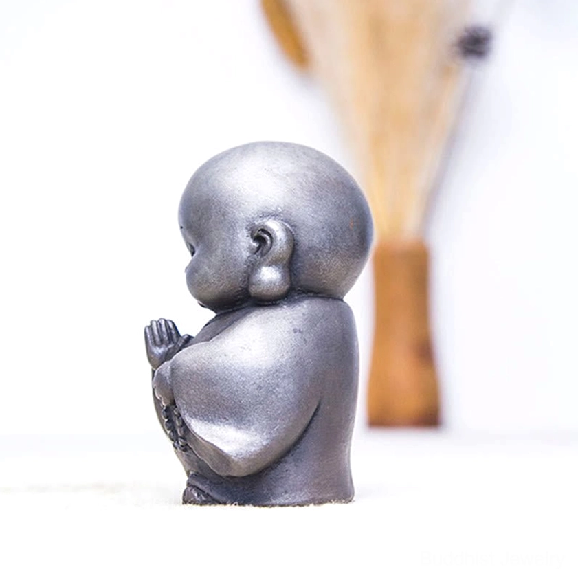 Buddhist meditation monk statue with weathered rust finish accent showing spiritual peaceful posture