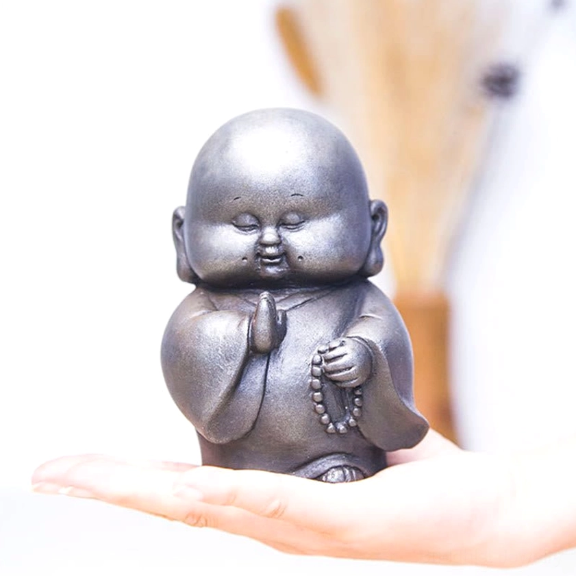 Buddhist monk statue polished finish alternative angle showing sleek dark grey refined aesthetic