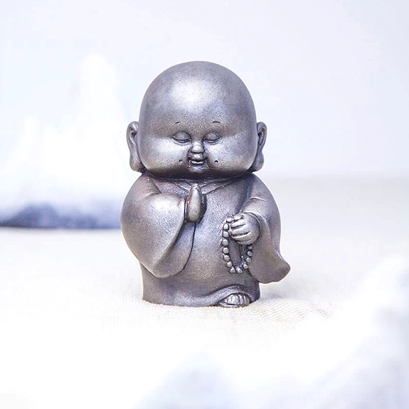 Buddhist monk resin decoration showing front perspective with prayer beads and contemplative expression
