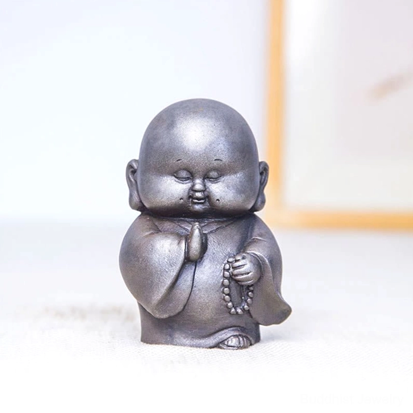 Buddhist monk resin ornament displaying rust version with aged weathered aesthetic and patina details