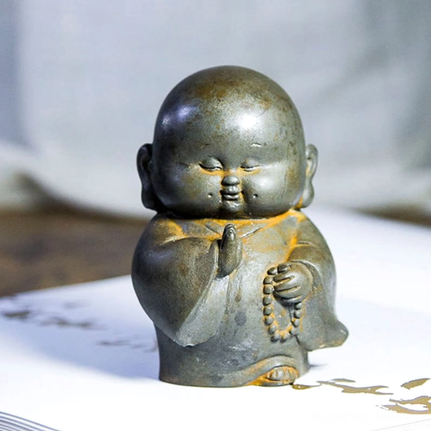 Buddhist monk resin statue seated in contemplative meditation position with authentic aged patina finish