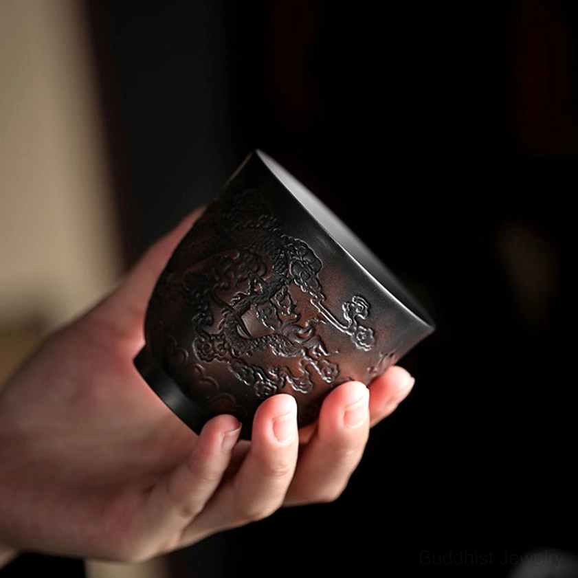 Handcrafted ceramic tea cup with traditional Buddhist motifs for yoga and meditation enthusiasts