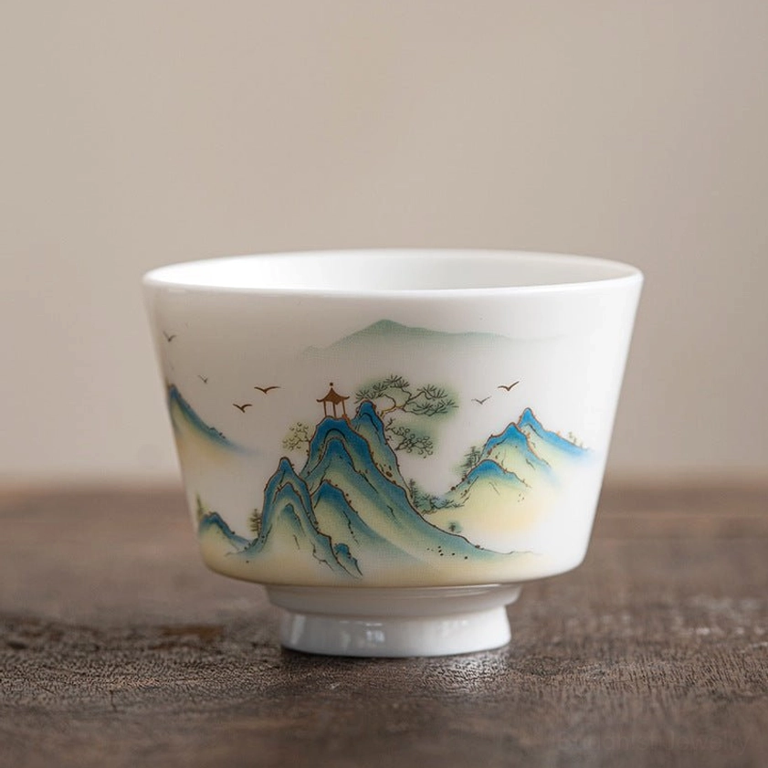 Buddhist-inspired mountain pavilion ceramic tea cup with hand-painted traditional Eastern architectural and nature elements