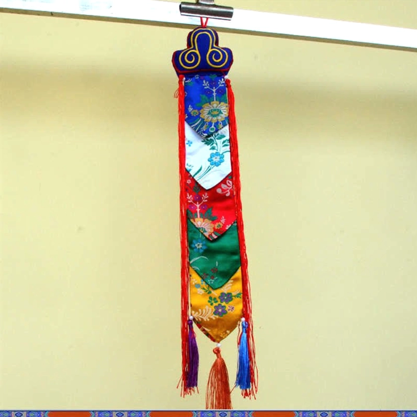 Multi-panel embroidered Buddhist tassel hanging with colorful bottom fringe on metal rod