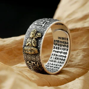 Chinese Zodiac Natal Buddha adjustable copper ring with vintage silver finish and gold-plated Buddha statue, shown on dry leaf with engraved sutras and cloud patterns