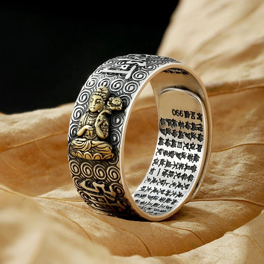 Chinese Zodiac Natal Buddha adjustable copper ring with vintage silver finish and gold-plated Buddha statue, shown on dry leaf with engraved sutras and cloud patterns