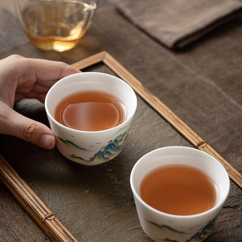 Premium Buddhist porcelain kung fu tea cup with traditional hand-painted nature and landscape elements for tea enthusiasts