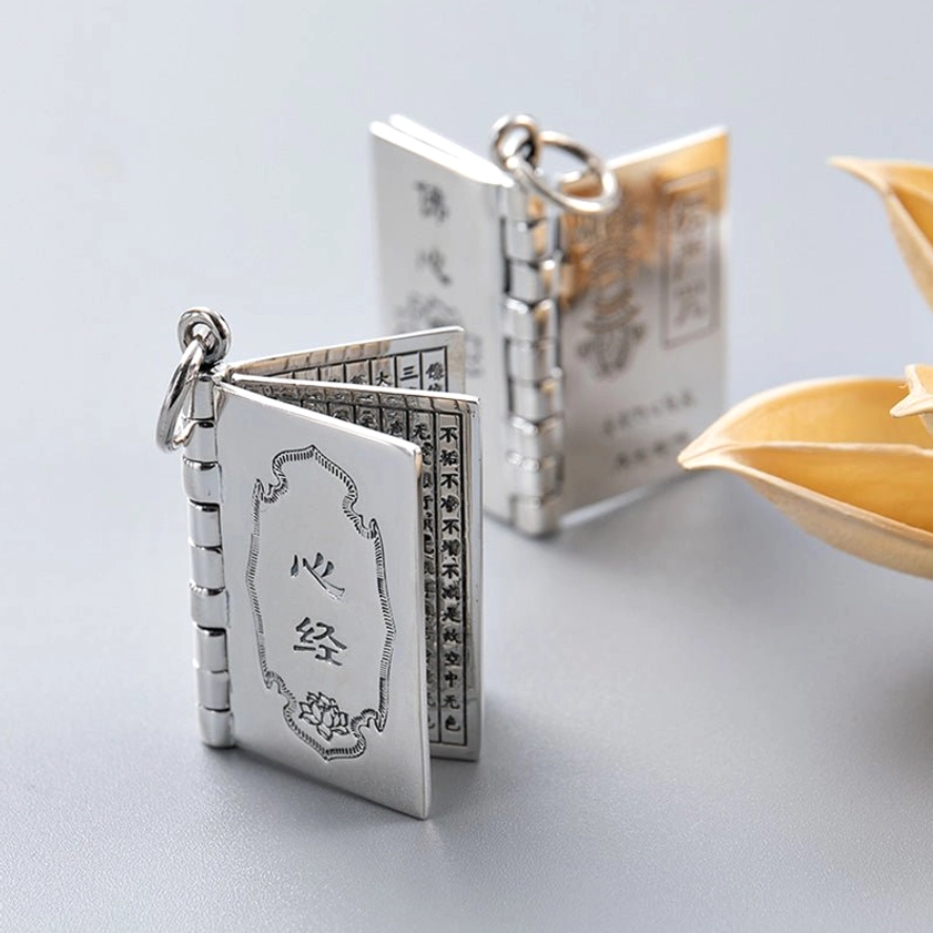 Silver Buddhist necklace pendant with lotus engraving and sacred sutra for inner peace and spiritual awakening