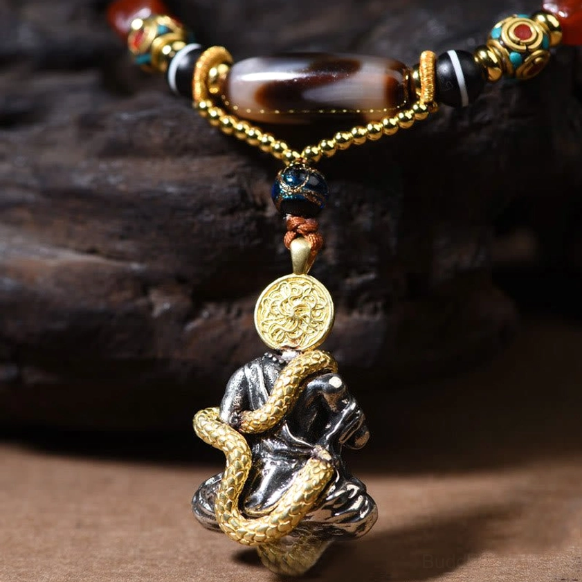 Dzi bead necklace coiled snake Buddha pendant front close-up view with brass and silver accents