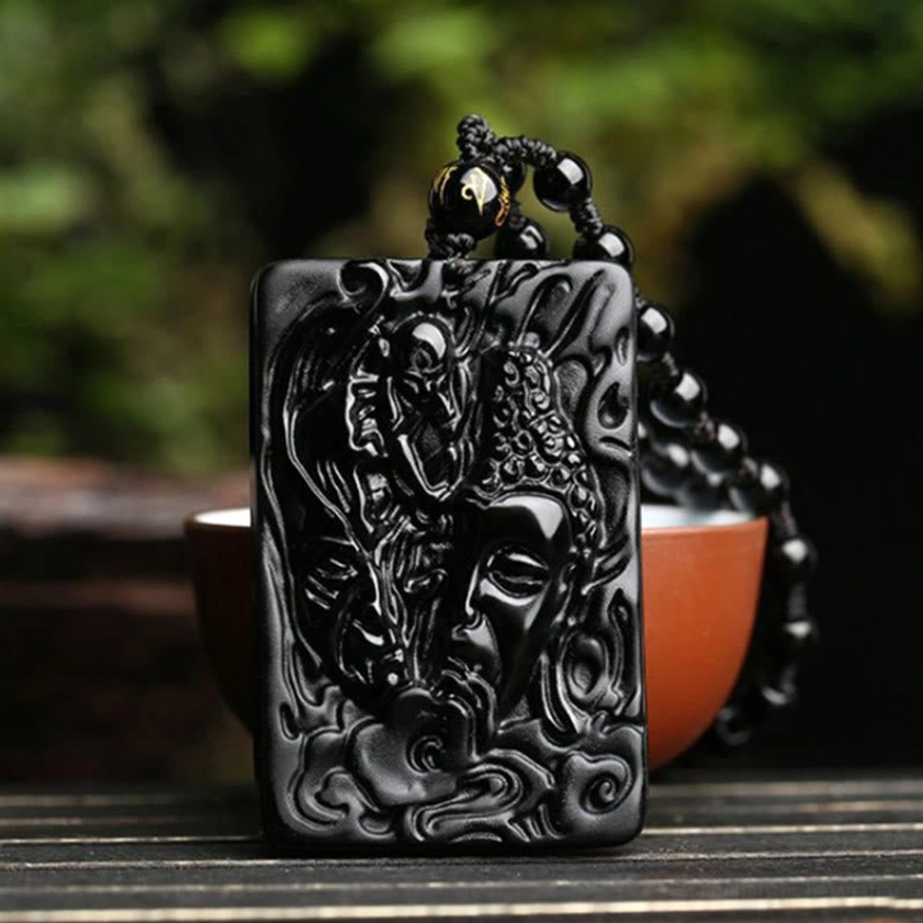 Buddhist Obsidian Pendant Necklace with Beaded Chain - Detail Shot with Red Ceramic Bowl