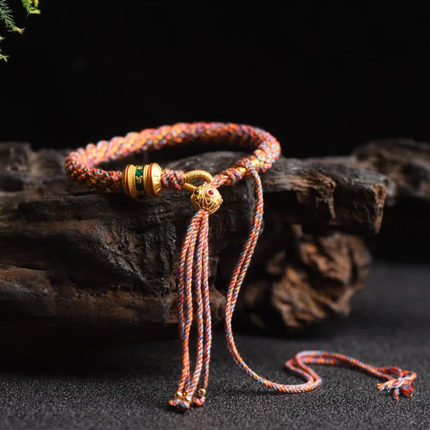 Orange and blue Buddhist prayer wheel braided lucky string bracelet with dual-color woven rope and metal accents