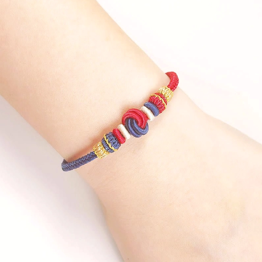 Buddhist lucky string bracelet worn on wrist showing multi-color braided eight-thread knot peace symbol