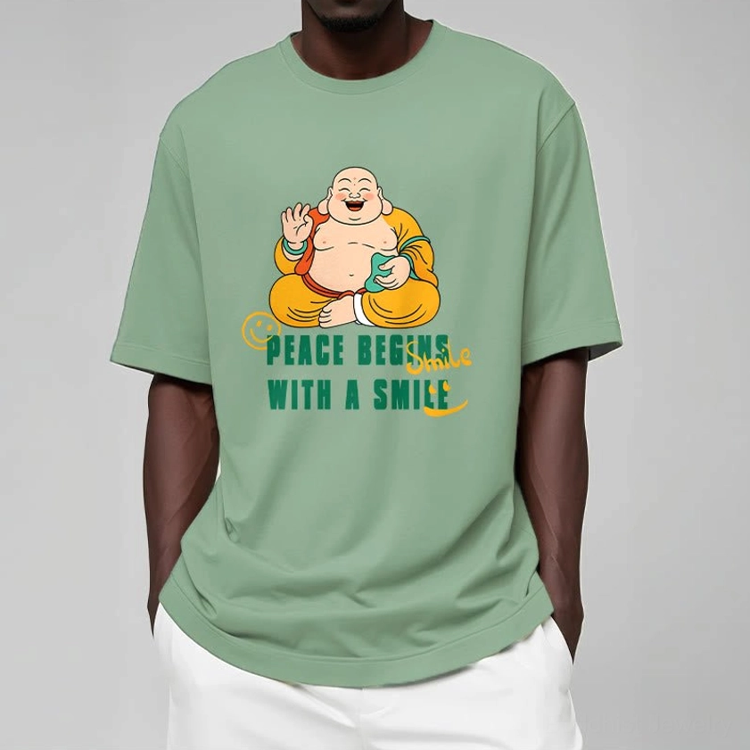 Male model wearing mint green Buddhist peace begins with smile graphic tee indoor casual display
