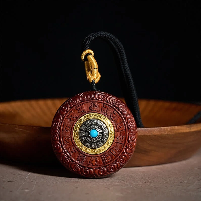 Back view of carved Buddhist mantra disc pendant with turquoise stone center inlay and red sandalwood frame