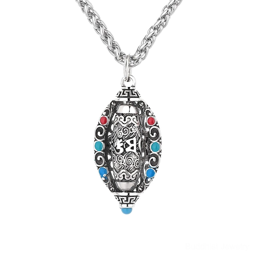 Buddhist Om mantra necklace pendant close-up on white background showing sacred sutra engraving and rotating core with vintage silver and gemstone finish