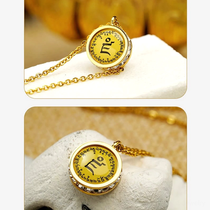 Flat lay Buddhist pendant necklace - gold chain with round mantra pendant on white display