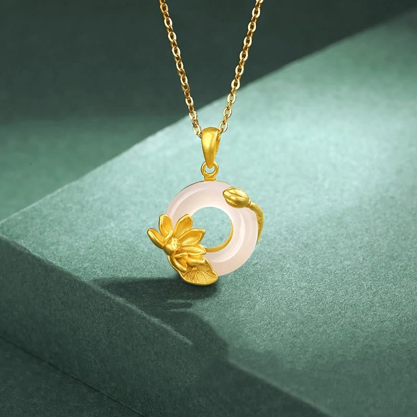 Sterling silver chalcedony lotus peace buckle necklace displaying delicate gold lotus design and dainty chain