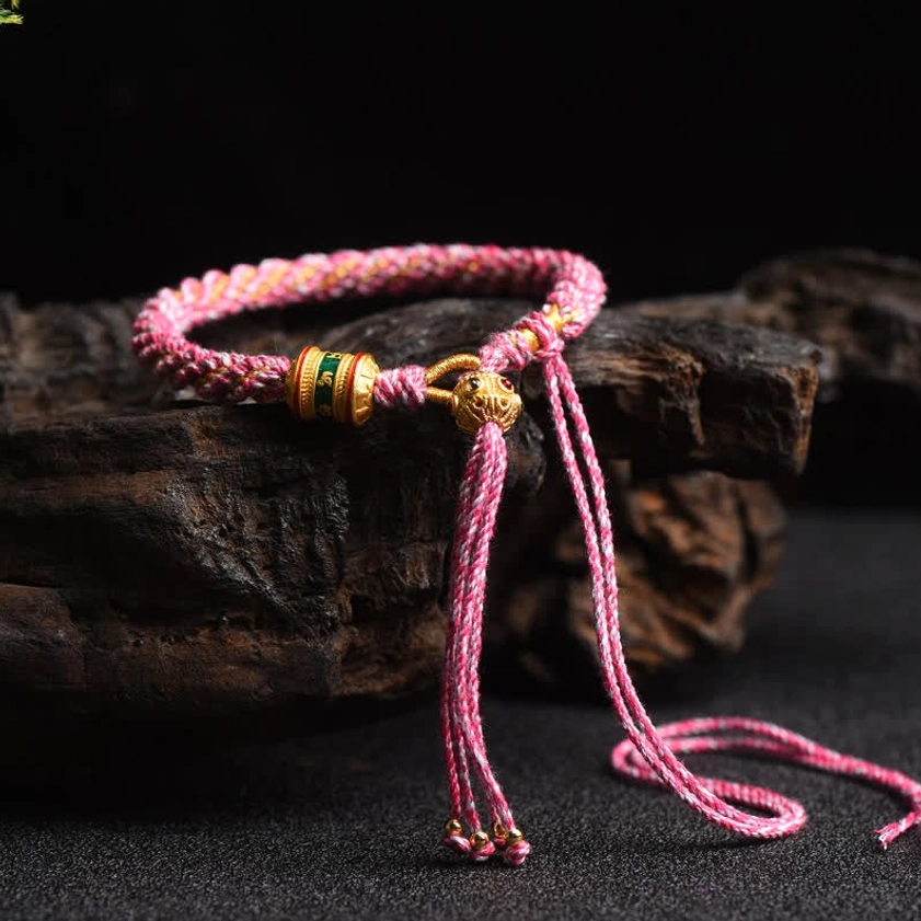 Pink Buddhist prayer wheel lucky string bracelet with handwoven braided cord and adjustable beaded tassel