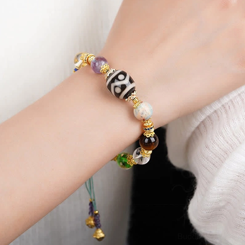 Buddhist prayer bracelet with Dzi bead amethyst tiger eye stones showing spiritual symbolism and natural materials