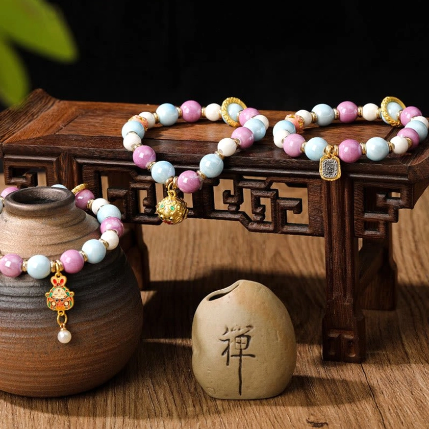 Handcrafted Buddhist prayer bracelet showcasing liuli glass beads and protective charm details with artisanal craftsmanship and natural materials